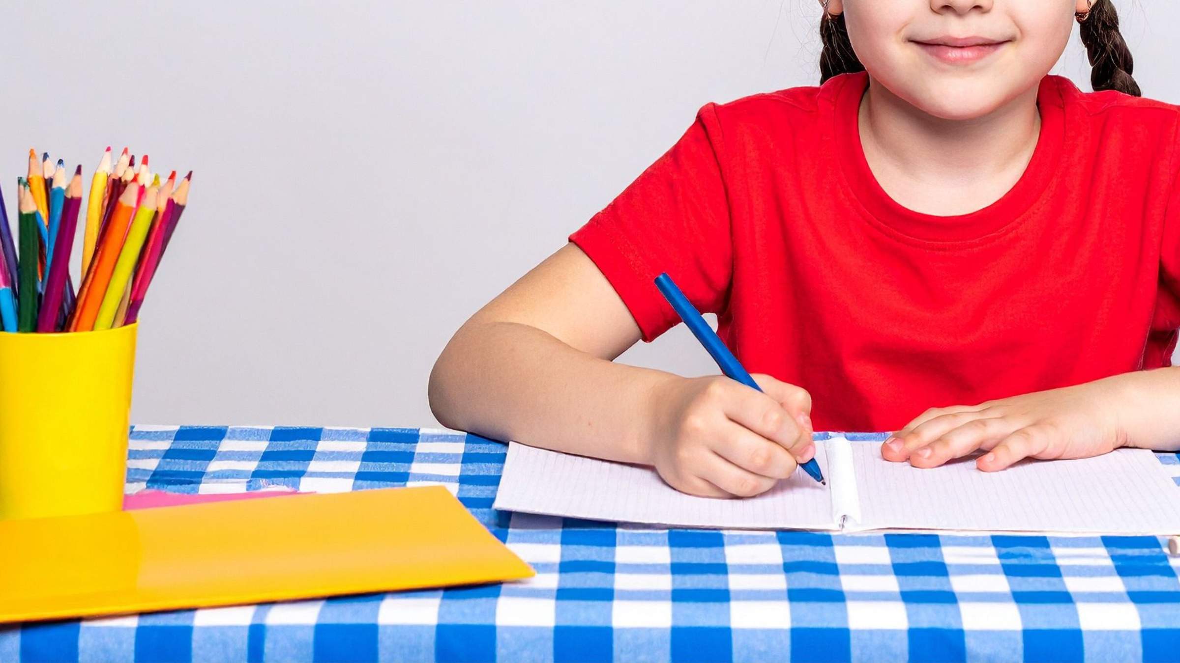 Family gathered around the table completing Bible copywork together